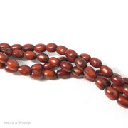 Dyed Magnesite Rust Rice/Barrel 8x6mm (16 Inch Strand)